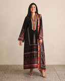 Woman wearing black printed raw silk suit with colourful striped dupatta border