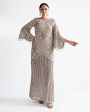 Woman wearing a Lilac Net suit embellished with pearls, crystals, and dabka embroidery