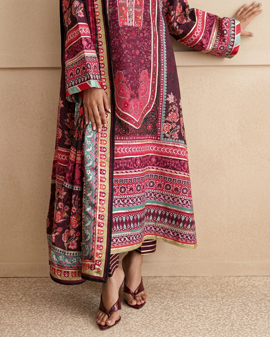 Close-up of embroidered hem lace and striped trouser on deep purple printed raw silk suit