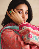 Close-up of embroidered neckline and printed sleeve on peach raw silk shirt