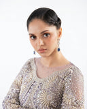 Close-up of the crystal and pearl embellished neckline on a Lilac Net suit
