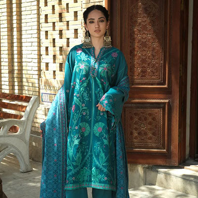 Mushq winter collection featuring an elegant teal embroidered unstitched suit with a matching shawl for women in Pakistan.