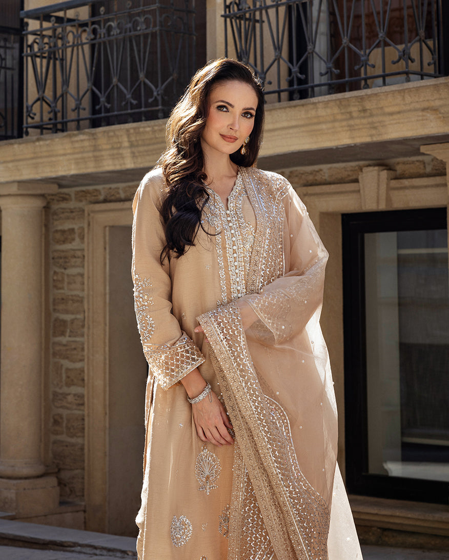 Woman wearing a Golden Beige Korean Raw Silk suit with pearl-finished embroidery detailing