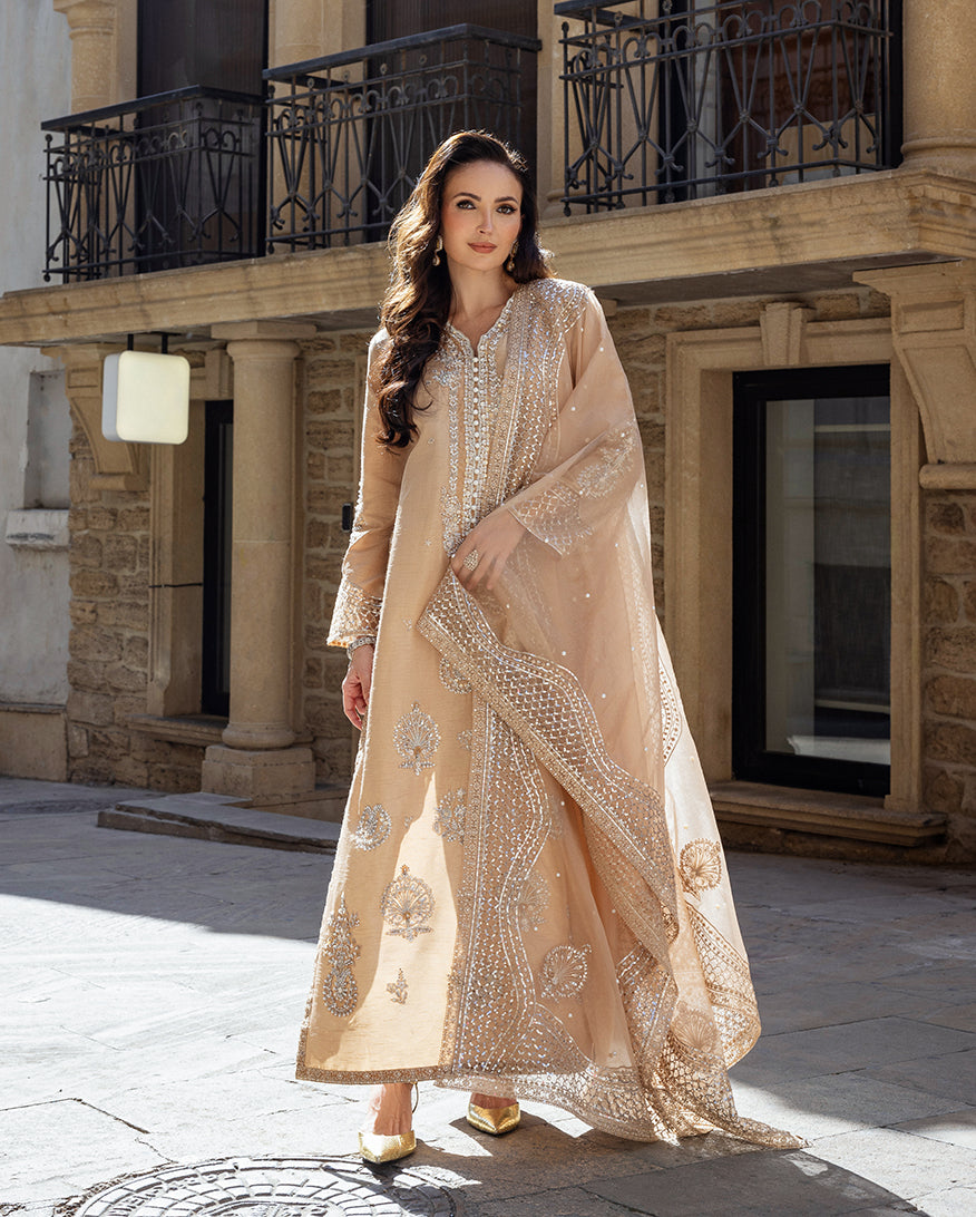 Woman wearing a Golden Beige embroidered Korean Raw Silk suit with tasseled neckline and sleeves