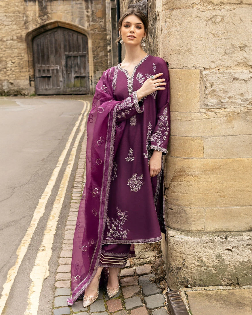 Woman wearing a Purple embroidered Raw Silk suit with resham and crystal embellishment