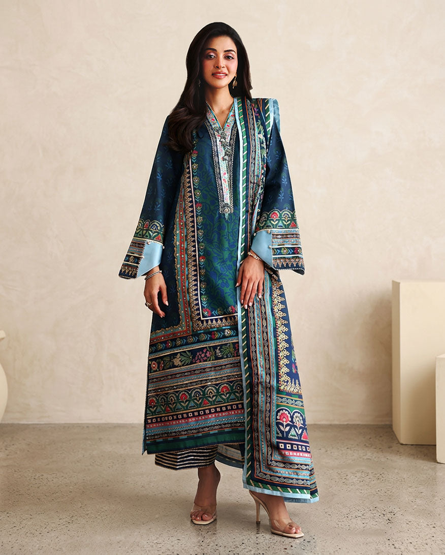 Woman wearing blue printed raw silk suit with striped trouser and teal dupatta