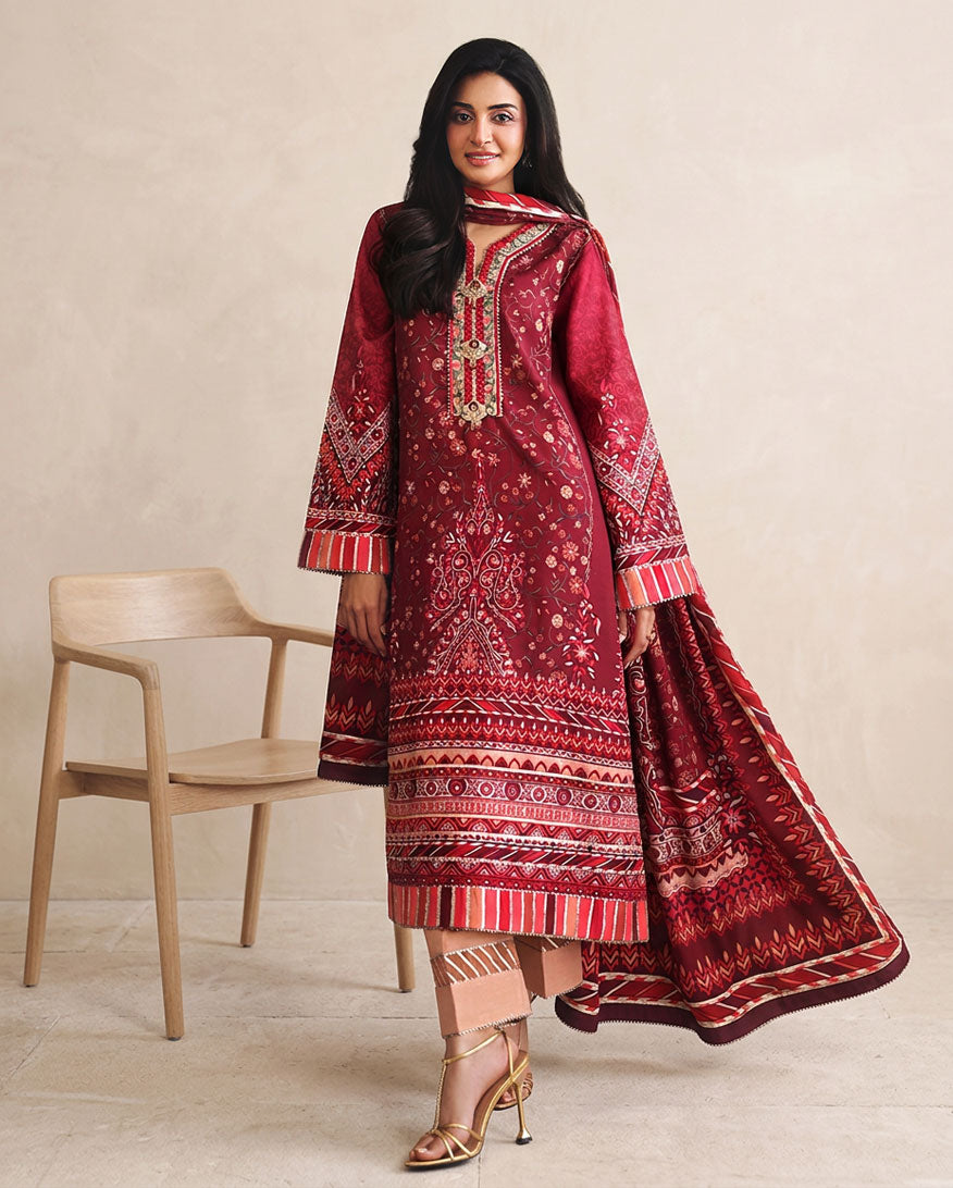 Woman wearing red printed raw silk suit with striped sleeve cuffs and dupatta