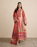 Woman wearing peach printed raw silk suit standing against a plain wall