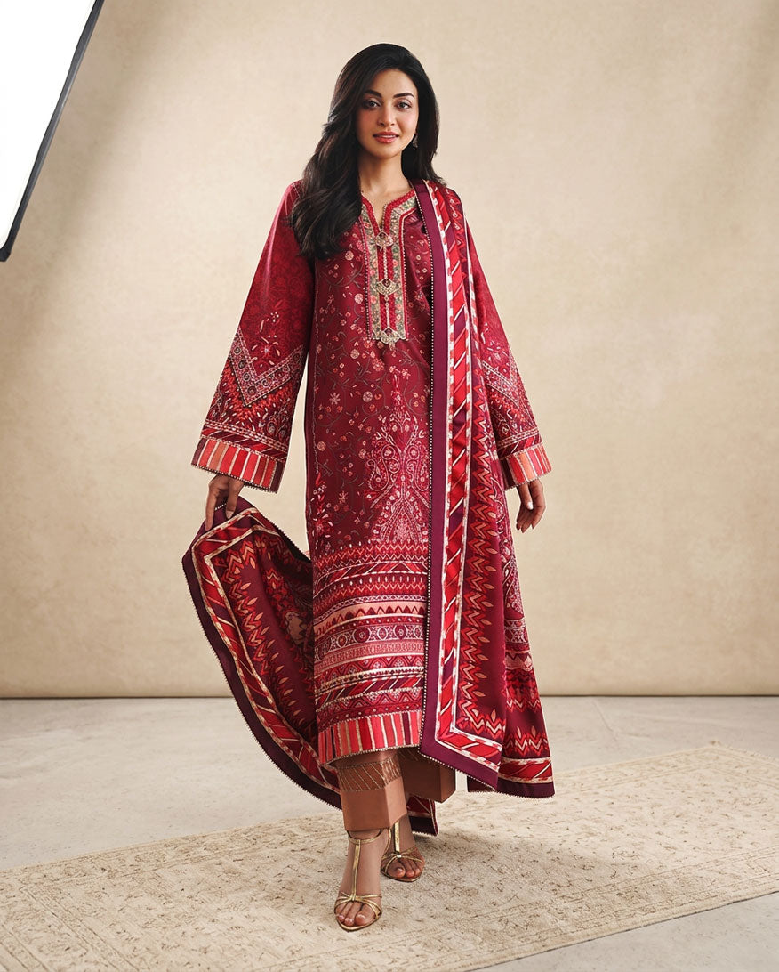 Woman wearing red printed raw silk suit walking with dupatta flowing
