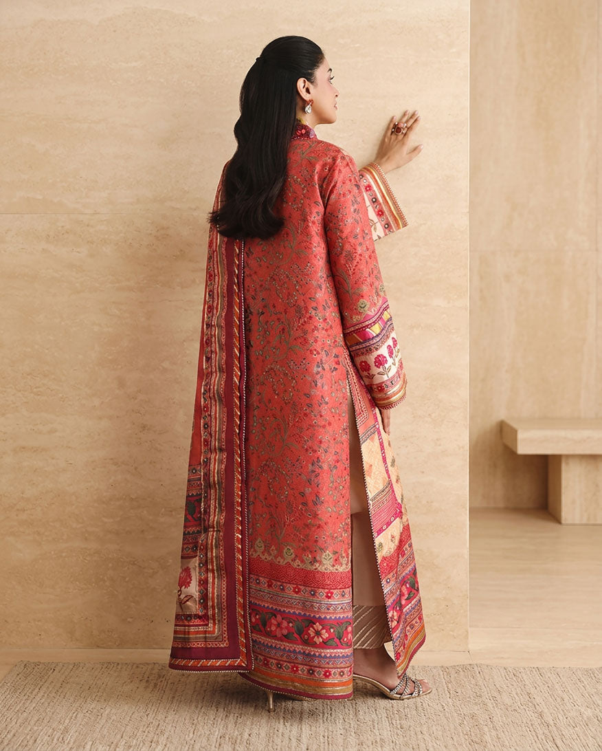 Back view of peach printed raw silk suit showing embroidered hem border and side slit
