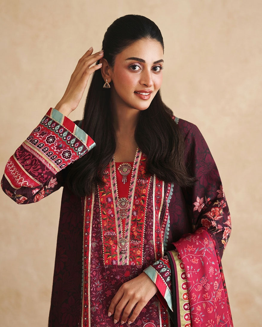 Close-up of embroidered neckline and printed sleeve on deep purple raw silk shirt