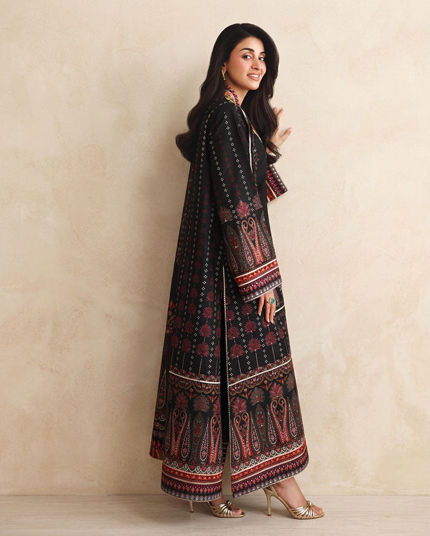 Side view of black printed raw silk suit showing striped dupatta and embroidered sleeve