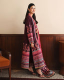 Side view of deep purple printed raw silk suit with pink embroidered dupatta draped over shoulder
