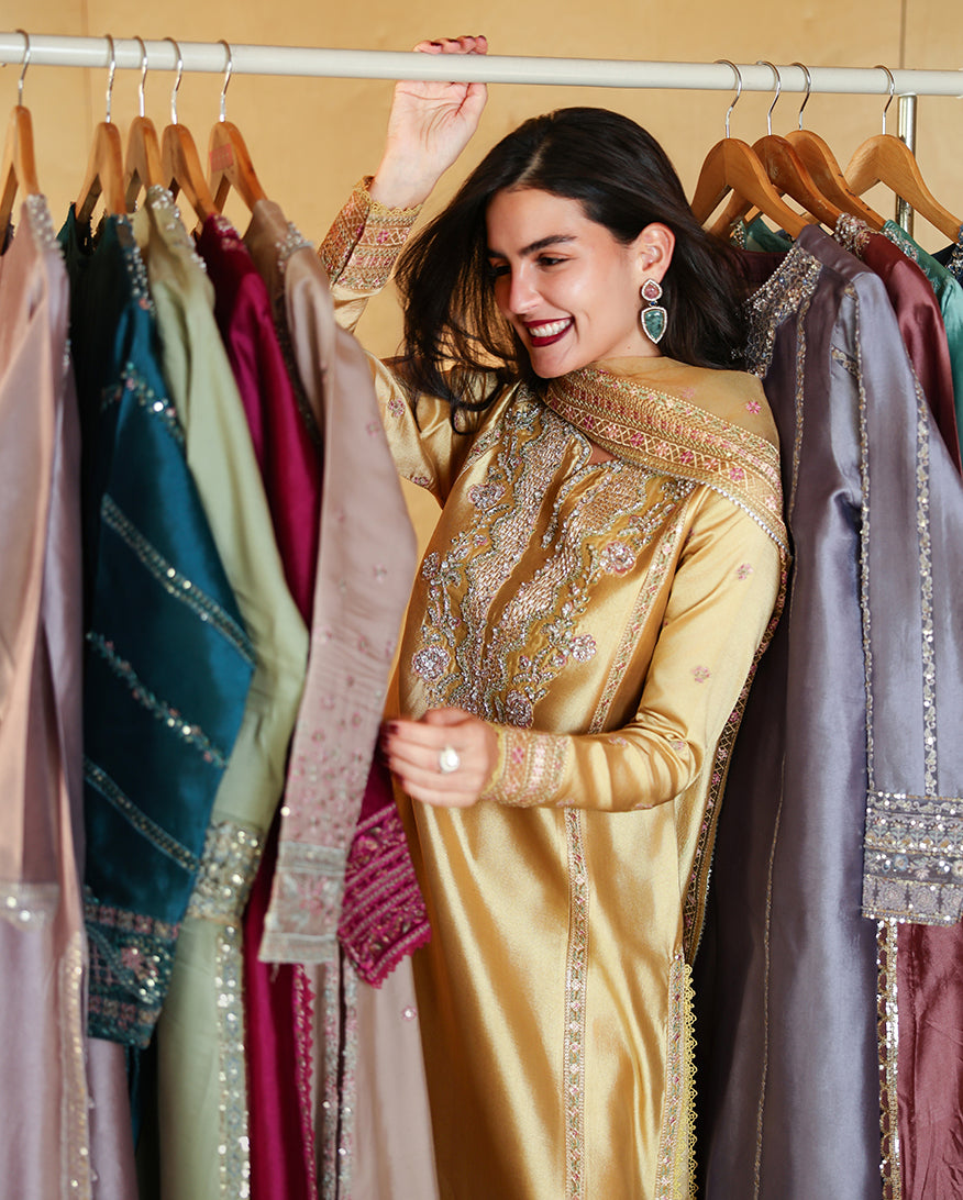 Candid shot of golden yellow luxury pret suit with embroidered neckline, Zarminay collection