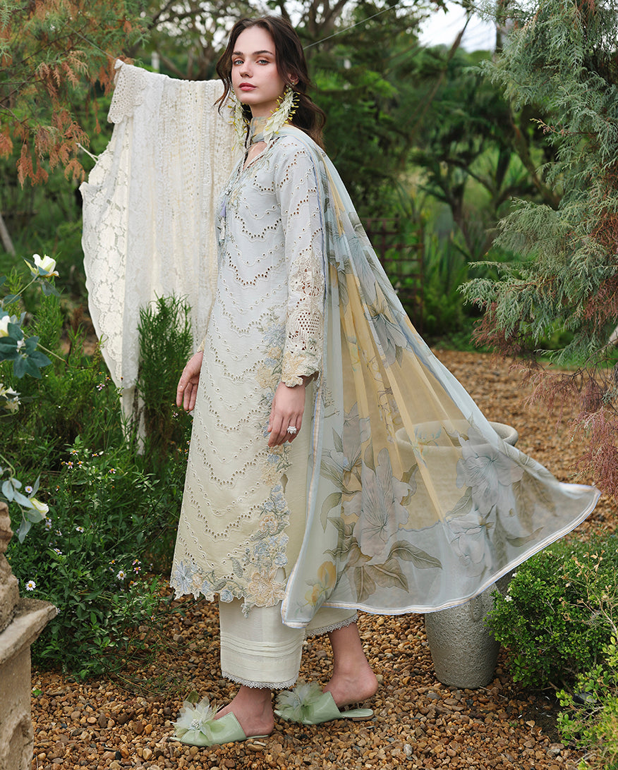 Side view of lemon yellow embroidered lawn unstitched suit, woman wearing sheer floral dupatta flowing, Secret Garden collection
