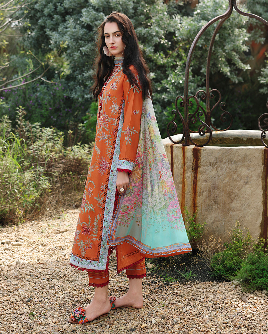 Side view of orange embroidered lawn collection suit with printed dupatta drape, Secret Garden collection