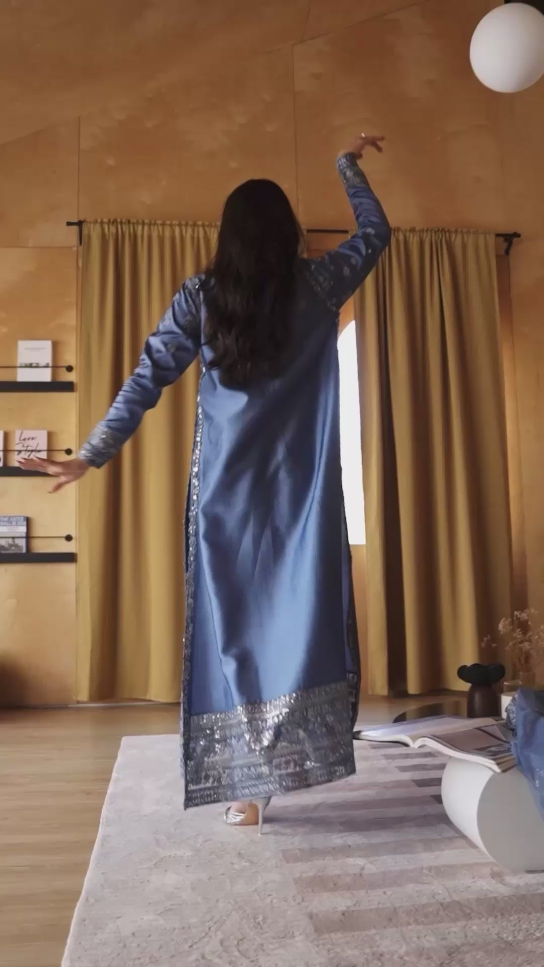 Woman wearing a blue satin embellished kurta with silver sequin-embroidered hem and dupatta border, styled in a wood-paneled interior, Zarminay | Luxury Pret collection