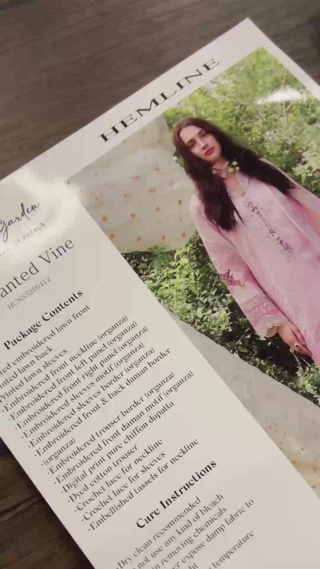 Flat-lay unboxing of light pink unstitched lawn suit fabric with lace appliques, Secret Garden collection